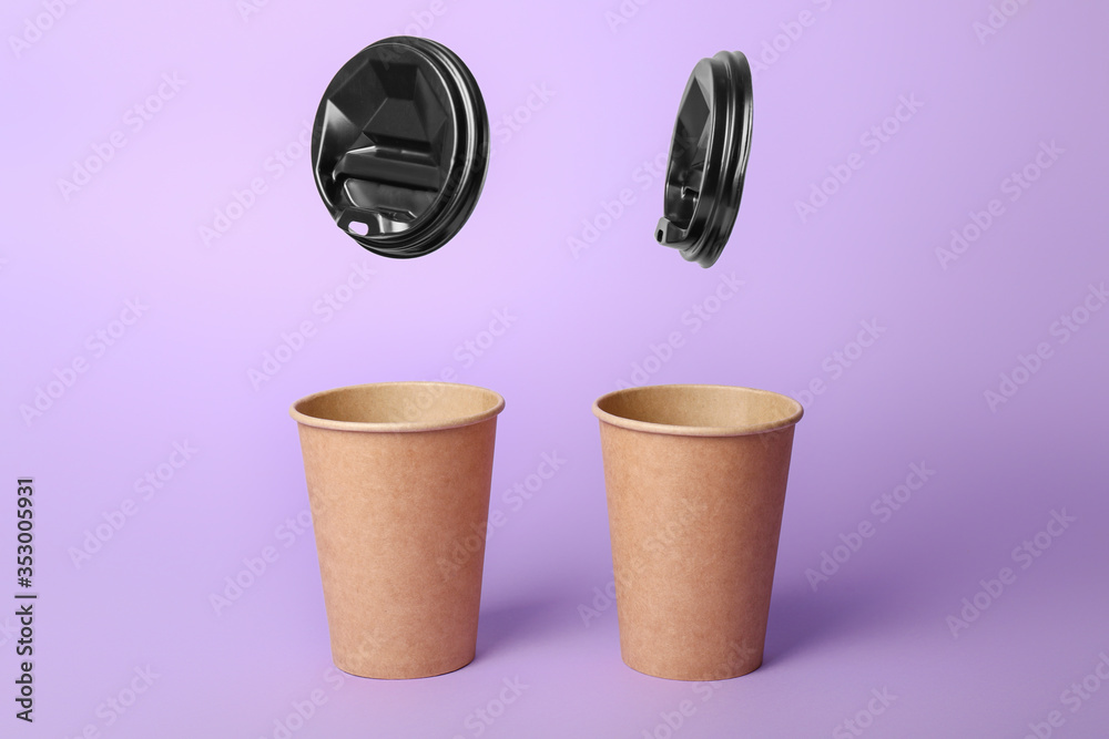 Takeaway coffee cups on color background