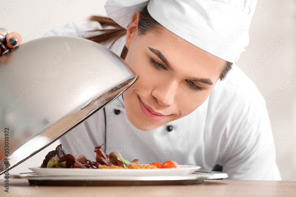 Transgender chef with tasty dish in kitchen