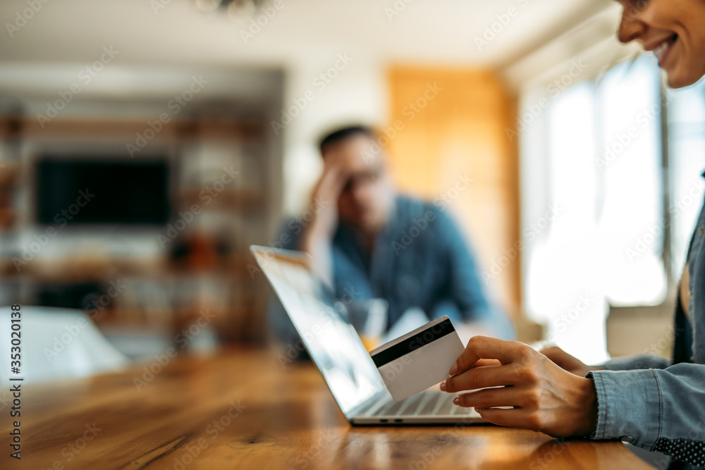 Woman holding credit card and using laptop. Online shopping, copy space.