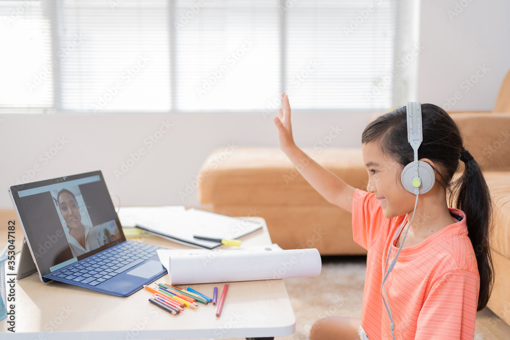 Asian girl Studying online with her teacher greeting