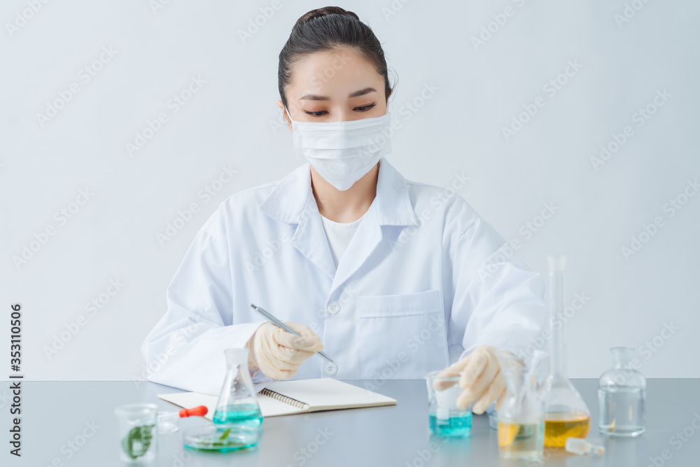 Female dermatologist doing research for new skin care product at table, closeup