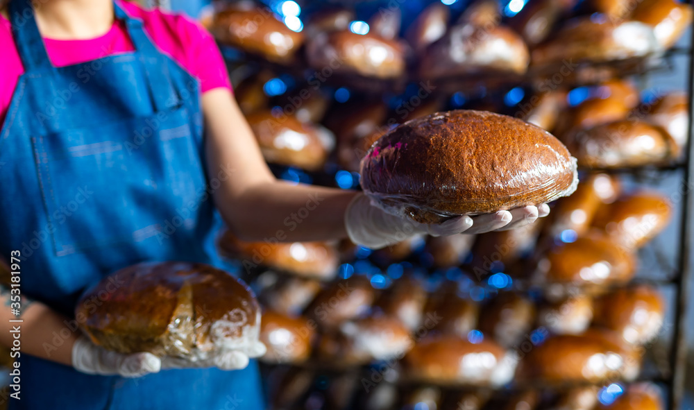 Woman holding tasty fresh bread, close up