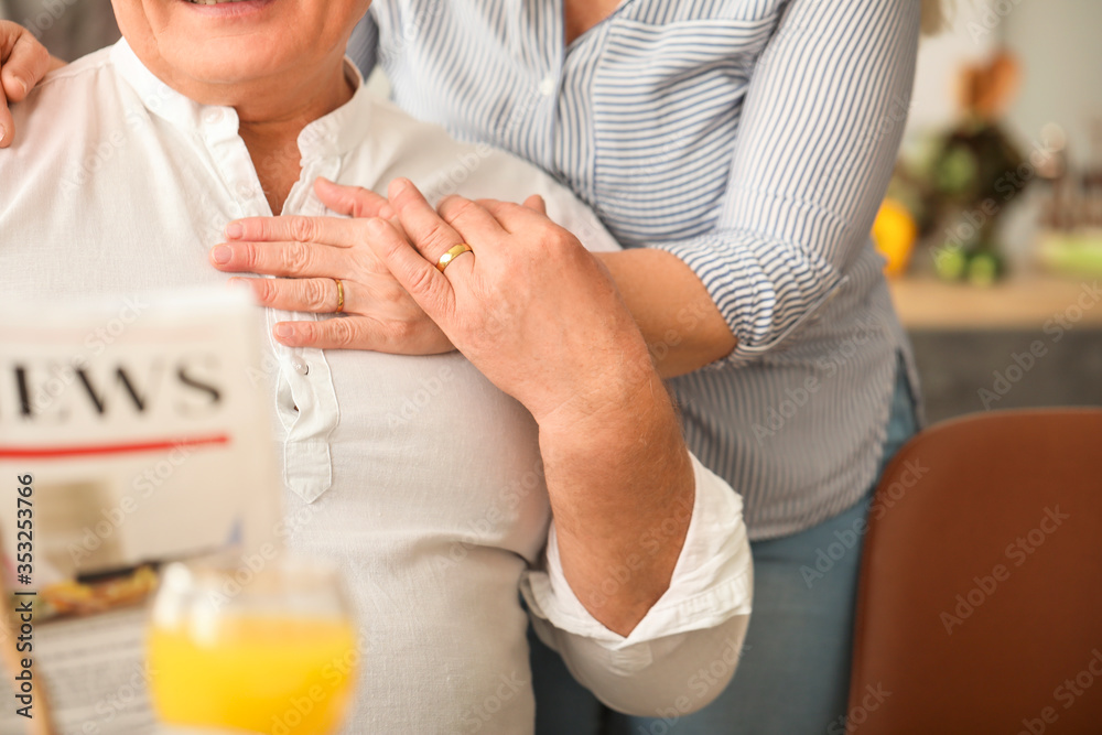 Happy elderly couple in kitchen