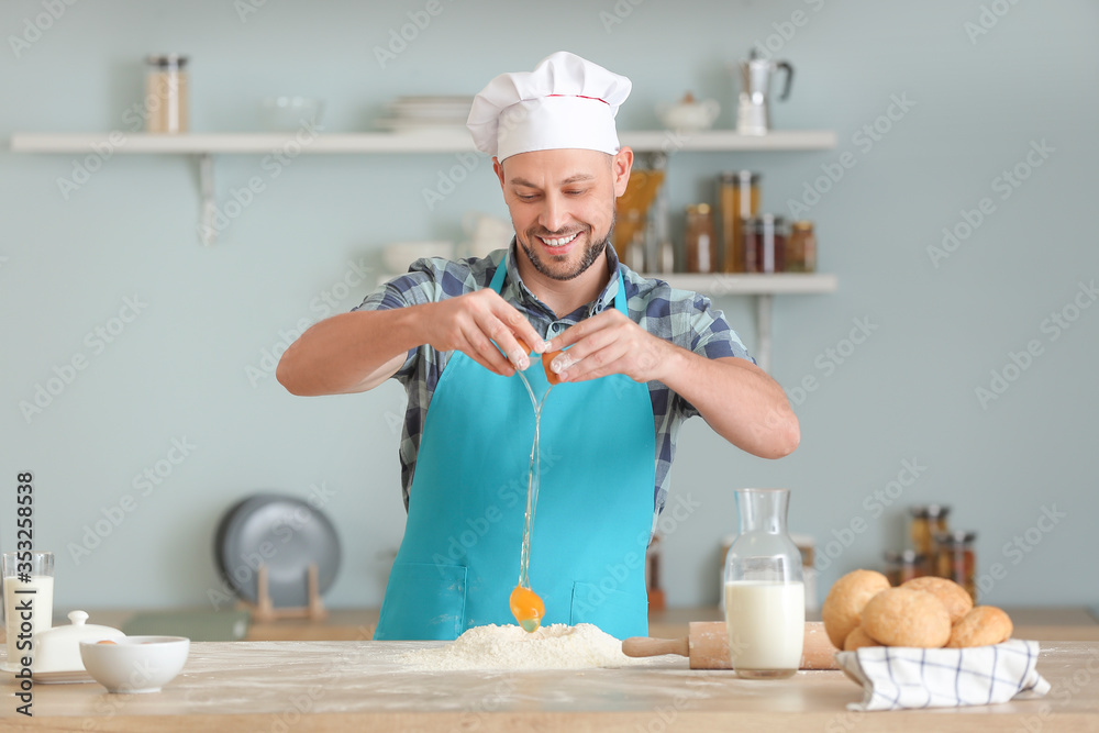 Handsome chef cooking in kitchen