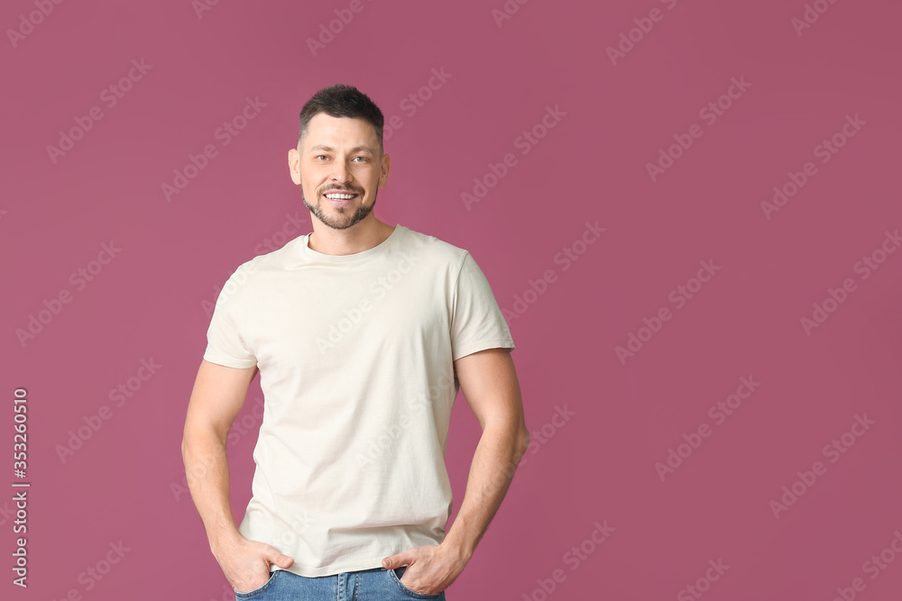 Man in stylish t-shirt on color background