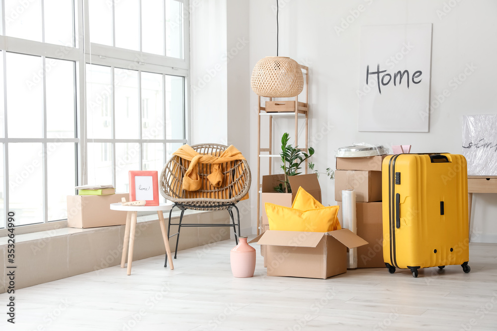 Cardboard boxes with belongings in new flat on moving day