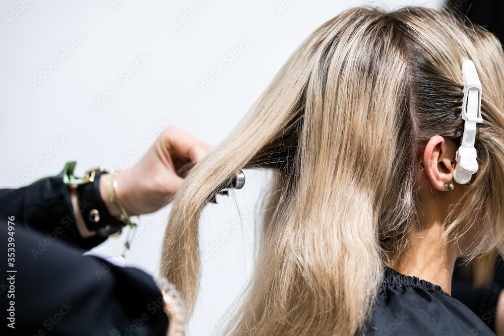 Professional hairdresser preparing client hair to haircut