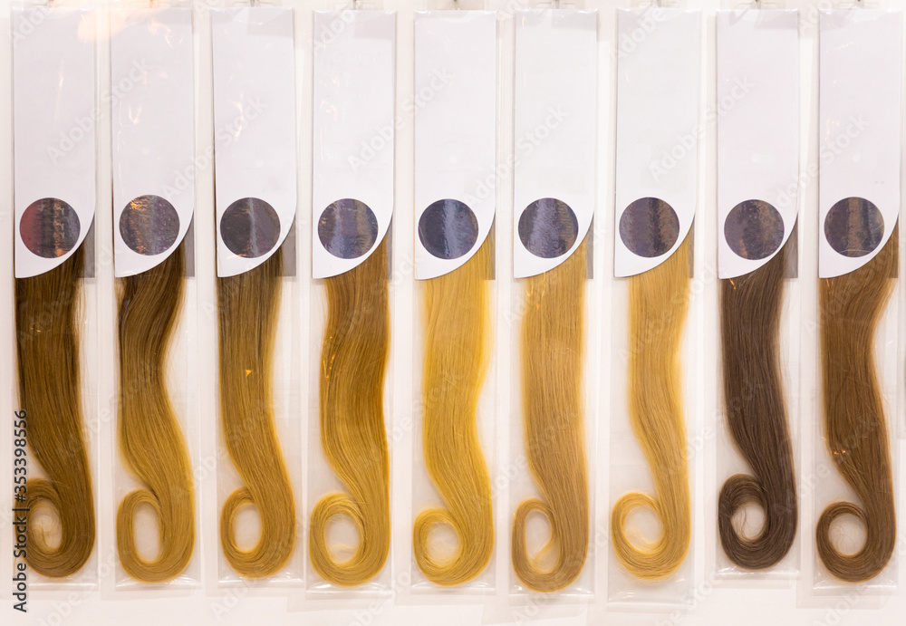 Exhibition of multicolored hair extensions in beauty salon