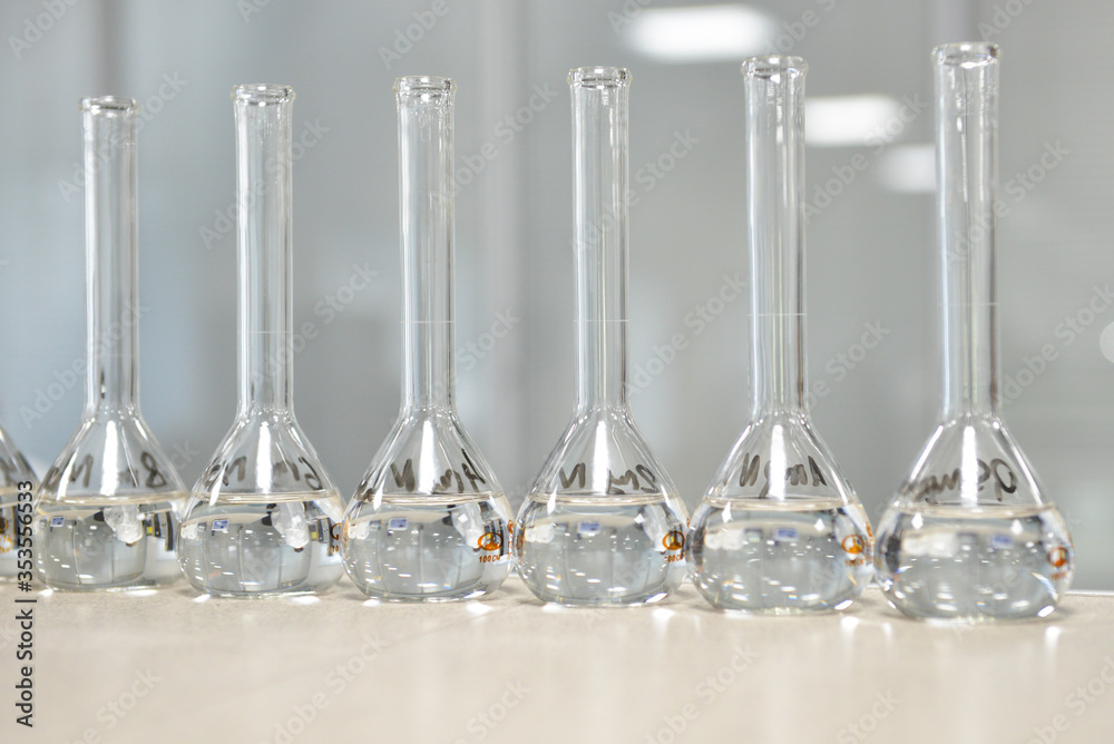 This is a stock photo that shows six glass flasks on a table.