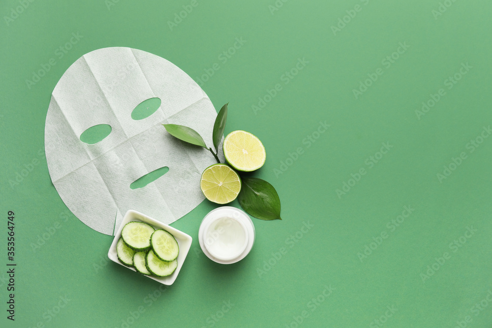 Composition with fabric facial mask, cream and cucumber on color background