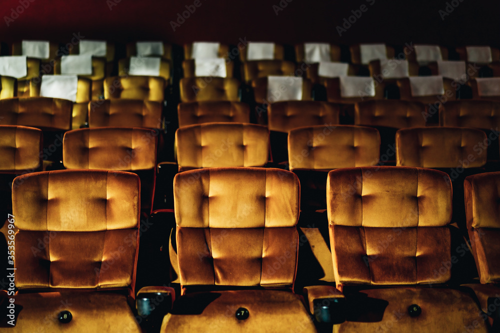 A row of yellow seat with popcorn on chair in the movie theater