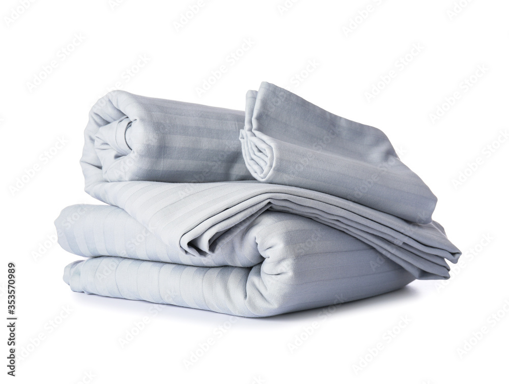 Stack of clean bed sheets on white background