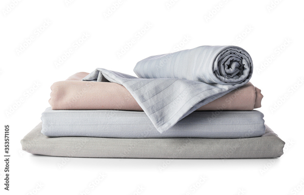 Stack of clean bed sheets on white background