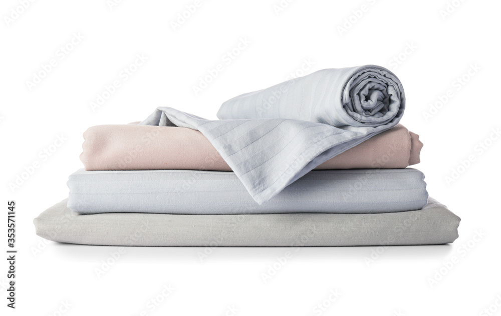 Stack of clean bed sheets on white background