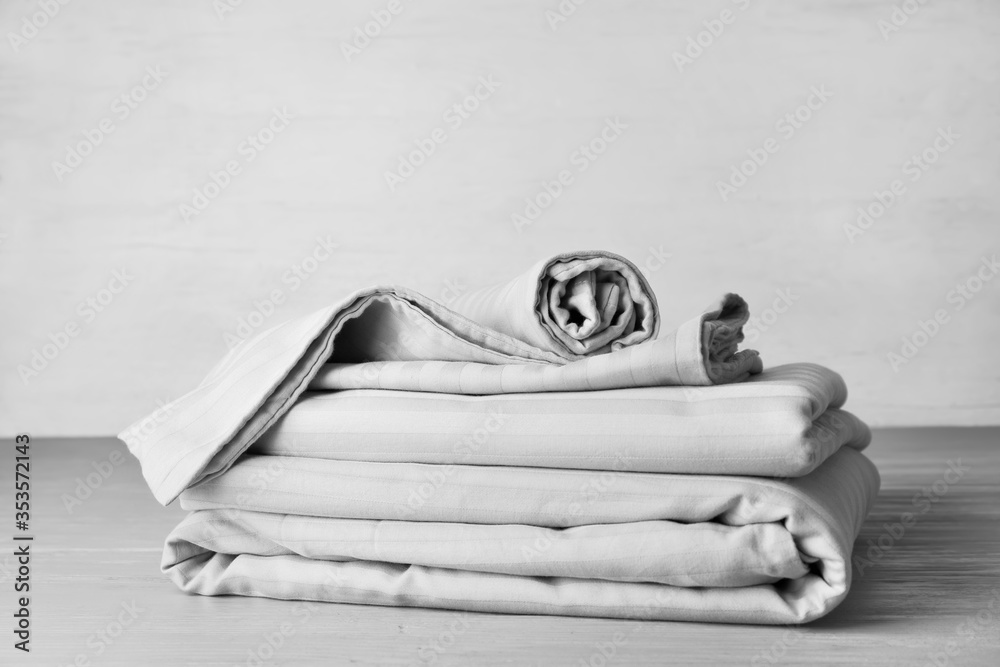 Stack of clean bed sheets on table