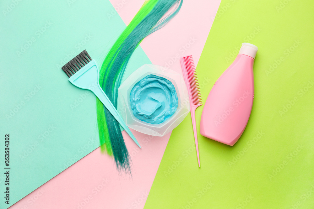 Supplies for hair coloring on color background