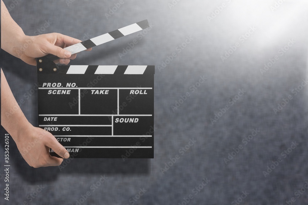 Female hands using classic film clapperboard