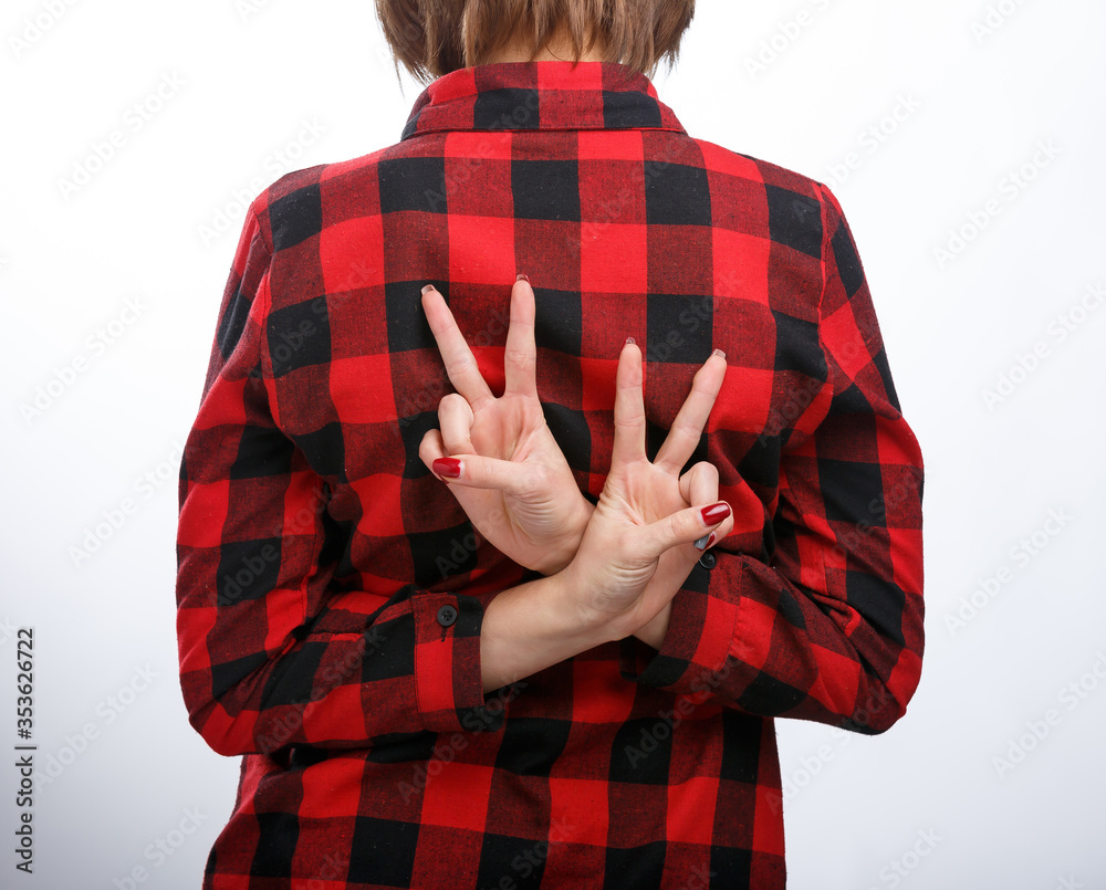 Young casual style woman portrait isolated over white background. View from the back. Hands behind b