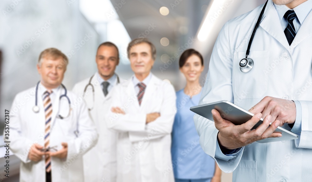 Male doctor working with digital tablet