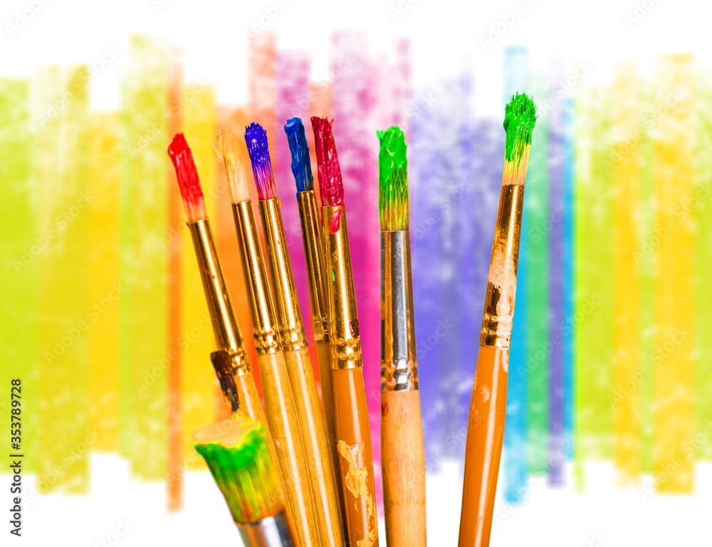 A row of artist paint brushes on desk