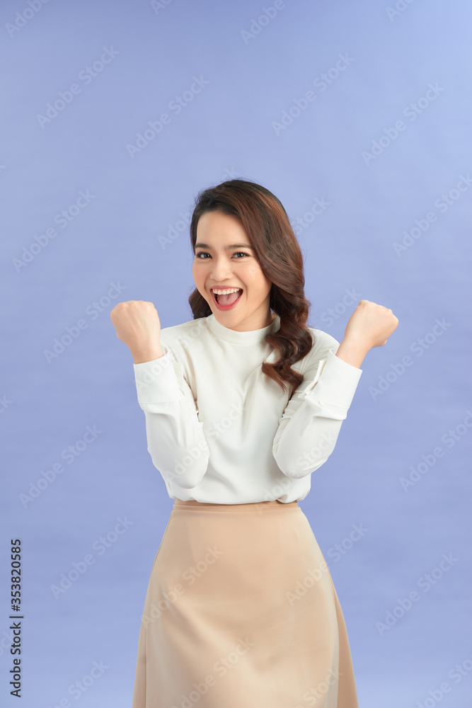 Young woman over isolated purple background celebrating a victory in winner position