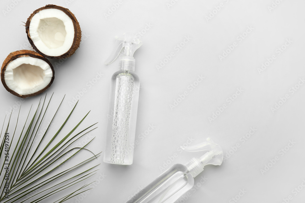 Hair sprays with coconut on light background