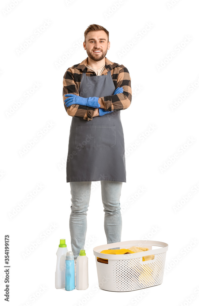 Young man with laundry on white background