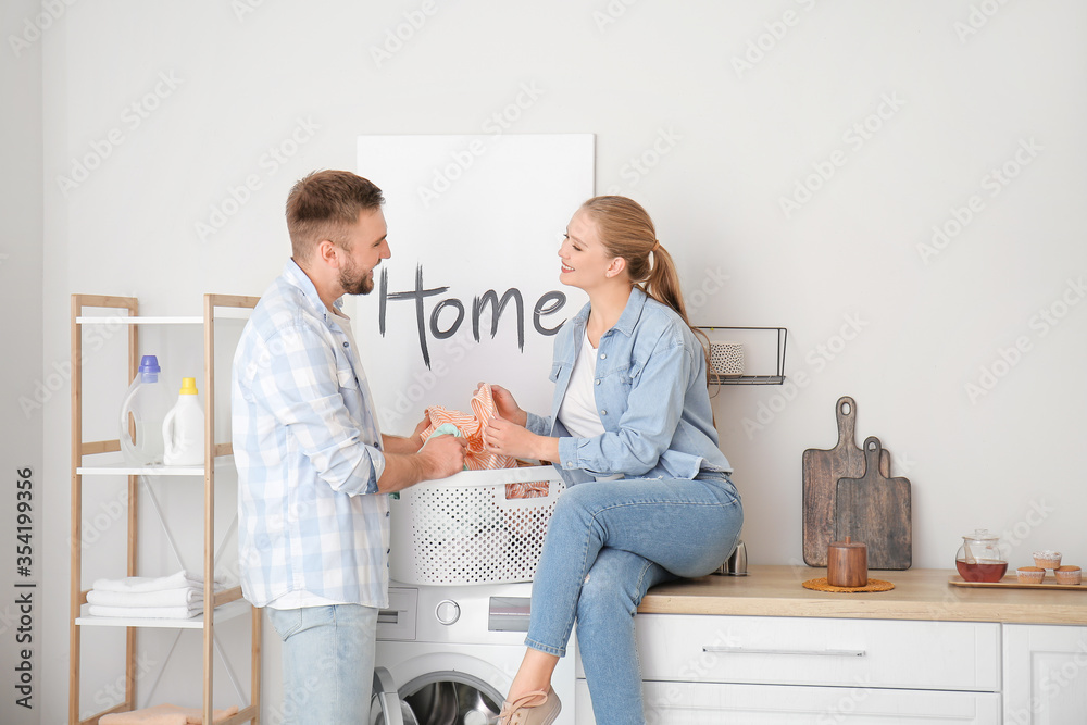 Happy couple doing laundry at home