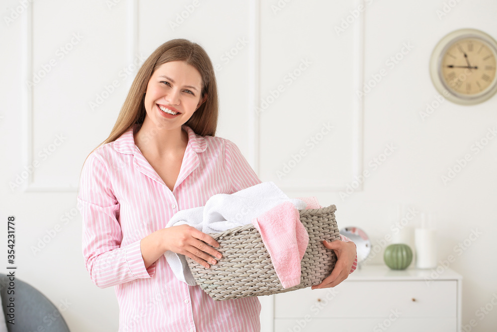 Young woman with clean laundry at home