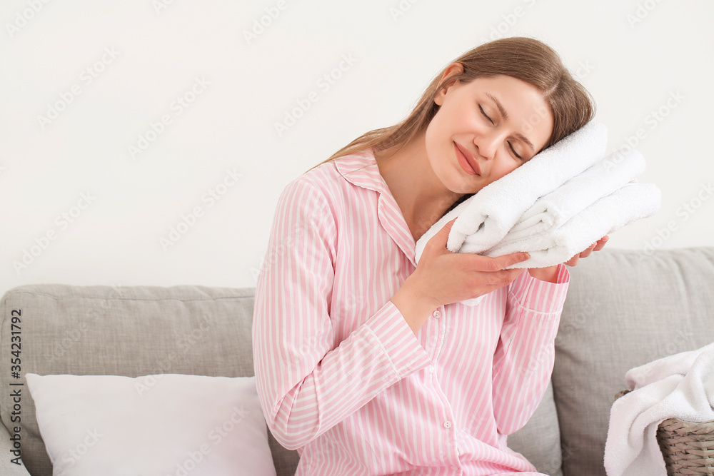 Young woman with clean laundry at home