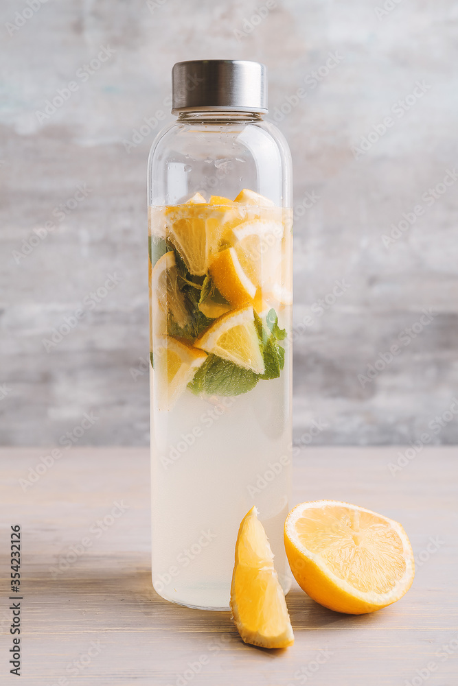 Bottle of fresh lemonade on table