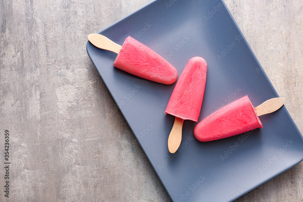 Plate with tasty strawberry ice cream on table