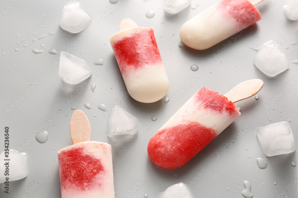 Tasty strawberry ice cream on grey background