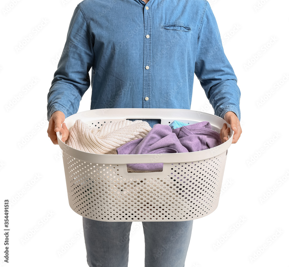 Young man with laundry on white background