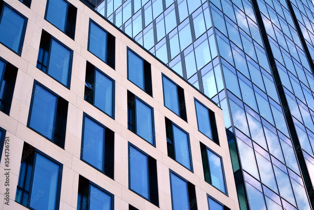 Facade texture of a glass mirrored office building. Fragment of the facade. Modern architecture of t