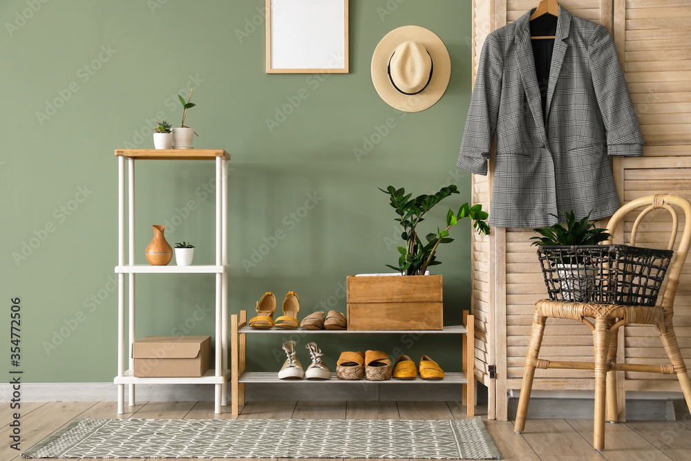 Stylish interior of modern hall with shoes on stand