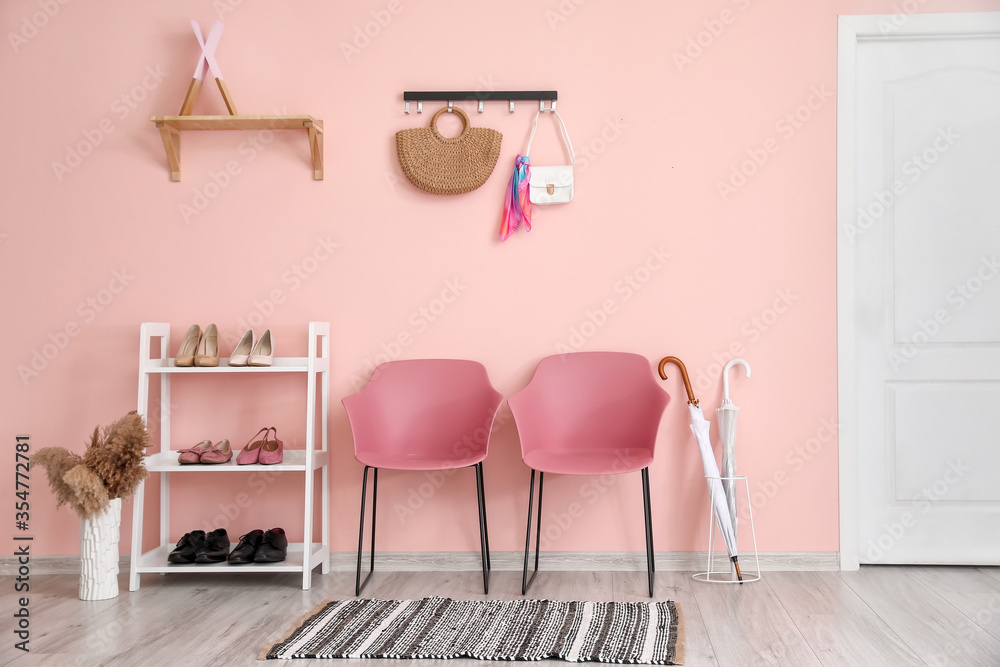 Stylish interior of modern hall with shoes on stand