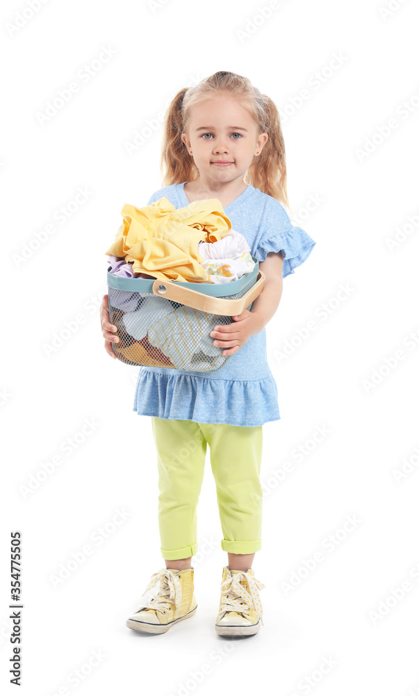 Cute little girl with dirty laundry on white background