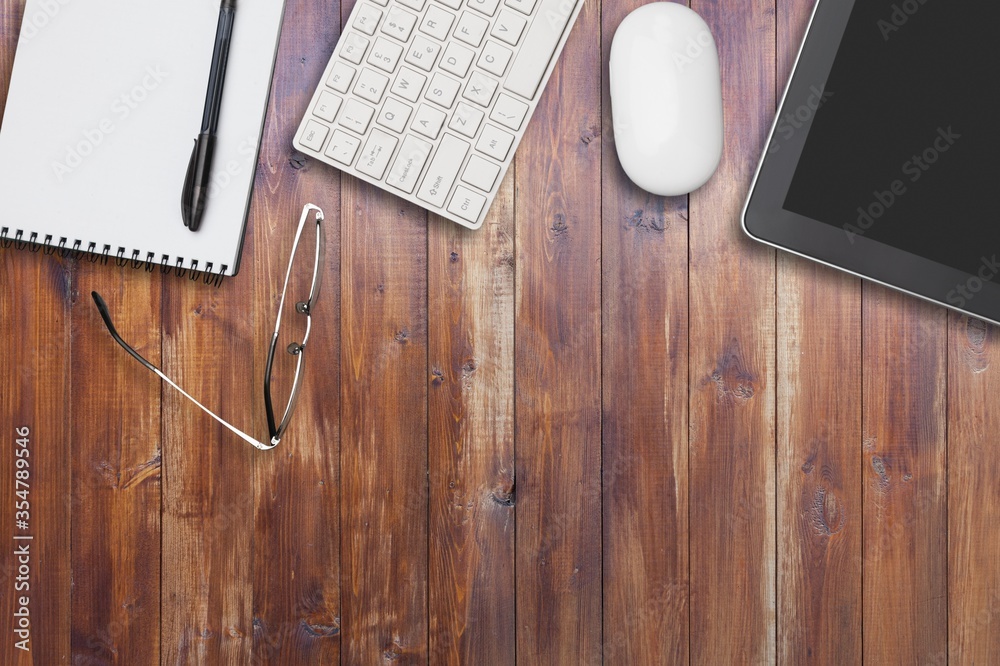 Workplace, laptop and tablet pc and phone on  table