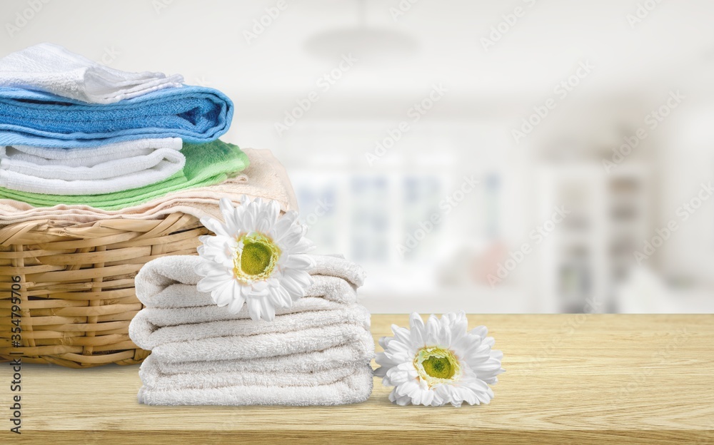 Laundry basket with colorful towels on desk