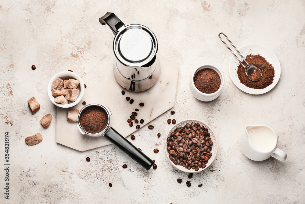 Composition with coffee beans and powder on light background