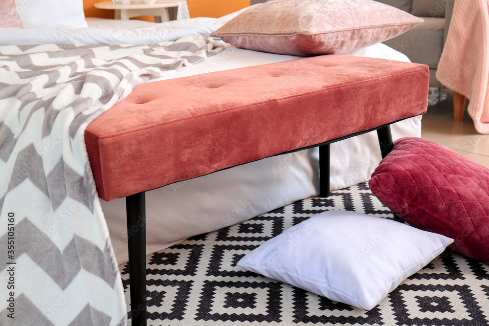 Big bed and bench in interior of modern room