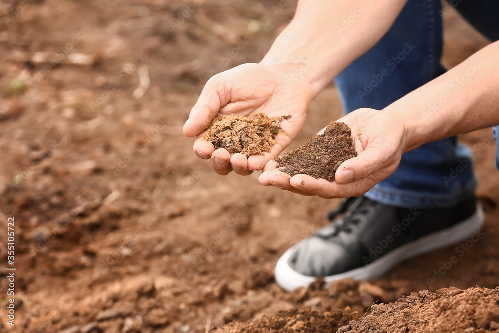 Man testing rich soil outdoors