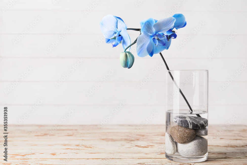 Beautiful orchid flowers in vase on table