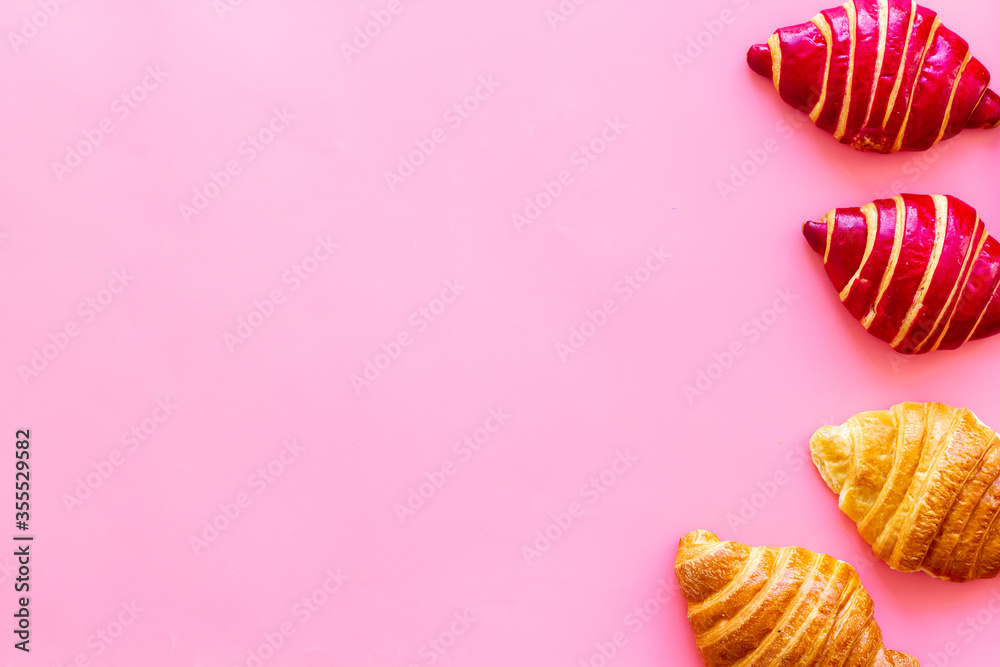 Set of croissants - berry, classic - on pink background top view