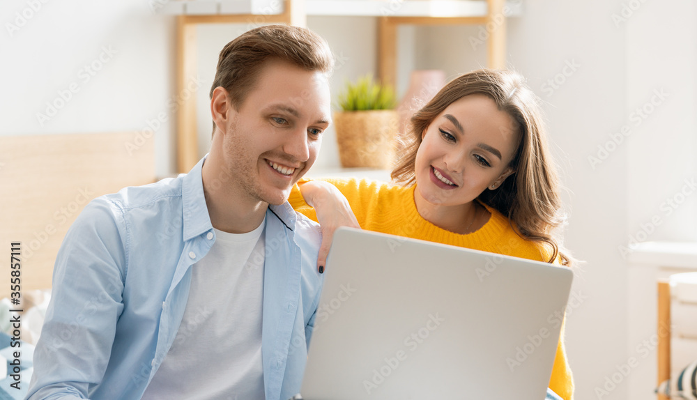 couple is using a laptop