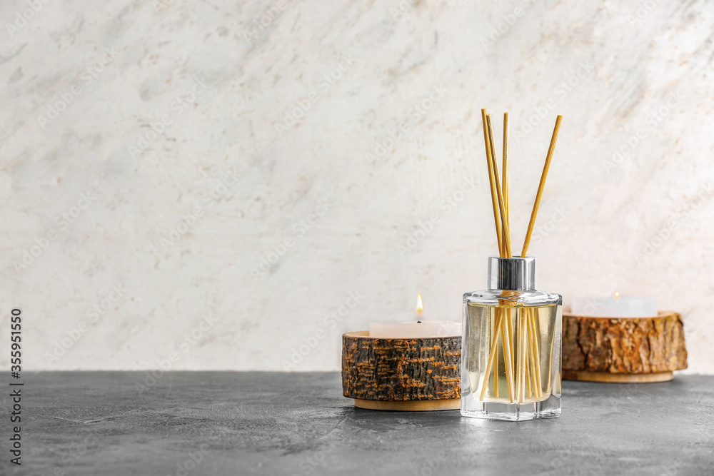 Reed diffuser and candles on table