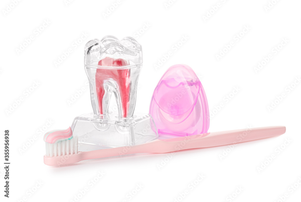 Toothbrush with dental floss, floss and tooth on white background