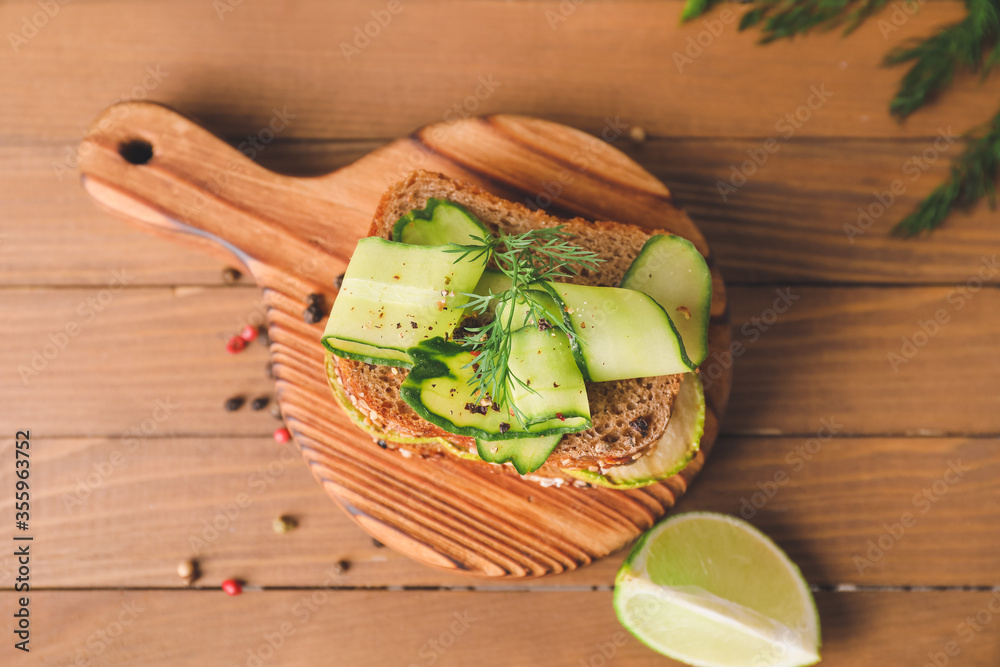 Tasty cucumber sandwich on table