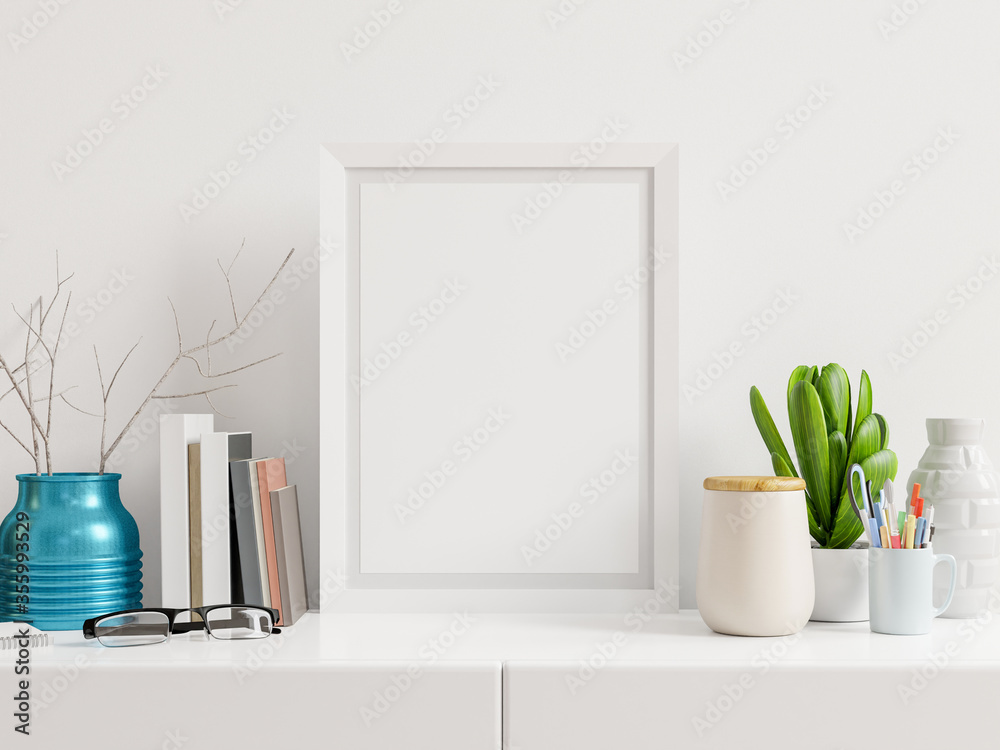 Poster mockup with vertical frame on table and white wall background.